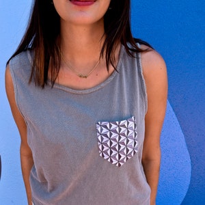 spaceshirt earth themed minimalist tank top in grey in front of the blueberry wall