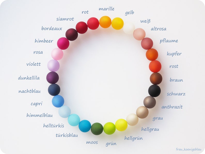 May include: A color wheel of 18 beads, each a different color, with the German name of the color written next to each bead.