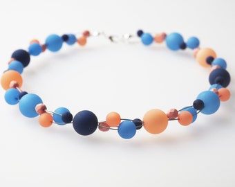 Geflochtene Polariskette in blau pfirsich Trendfarbe 2024 Peach Fuzz für einen modischen Akzent Halskette Kette Collier Sommerfarbe