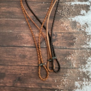 May include: Three leather cords with silver clasps. The cords are braided and come in brown and black.
