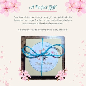 May include: A gift box tied with blue twine, featuring a circular label with a fox illustration and the text "Blue Dasher Alchemy." The box is adorned with a handmade charm and the text "A Perfect Gift!"
