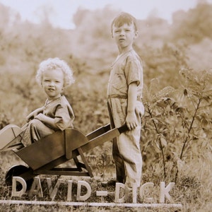 1930s Snapshot Photograph: Boy in Wheelbarrow with Brother