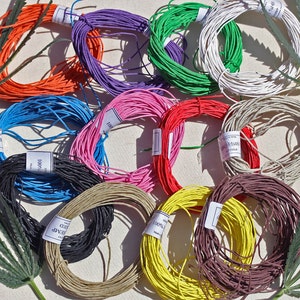 May include: Assortment of colourful 100% cotton twine spools in various colours, including orange, blue, purple, green, pink, red, brown, yellow, and natural.