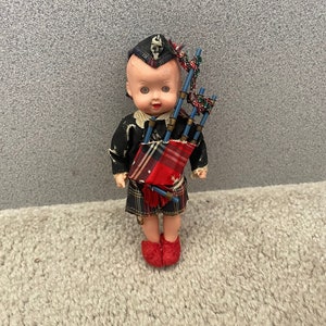 Vintage Boy doll with bagpipes Eyes open and close