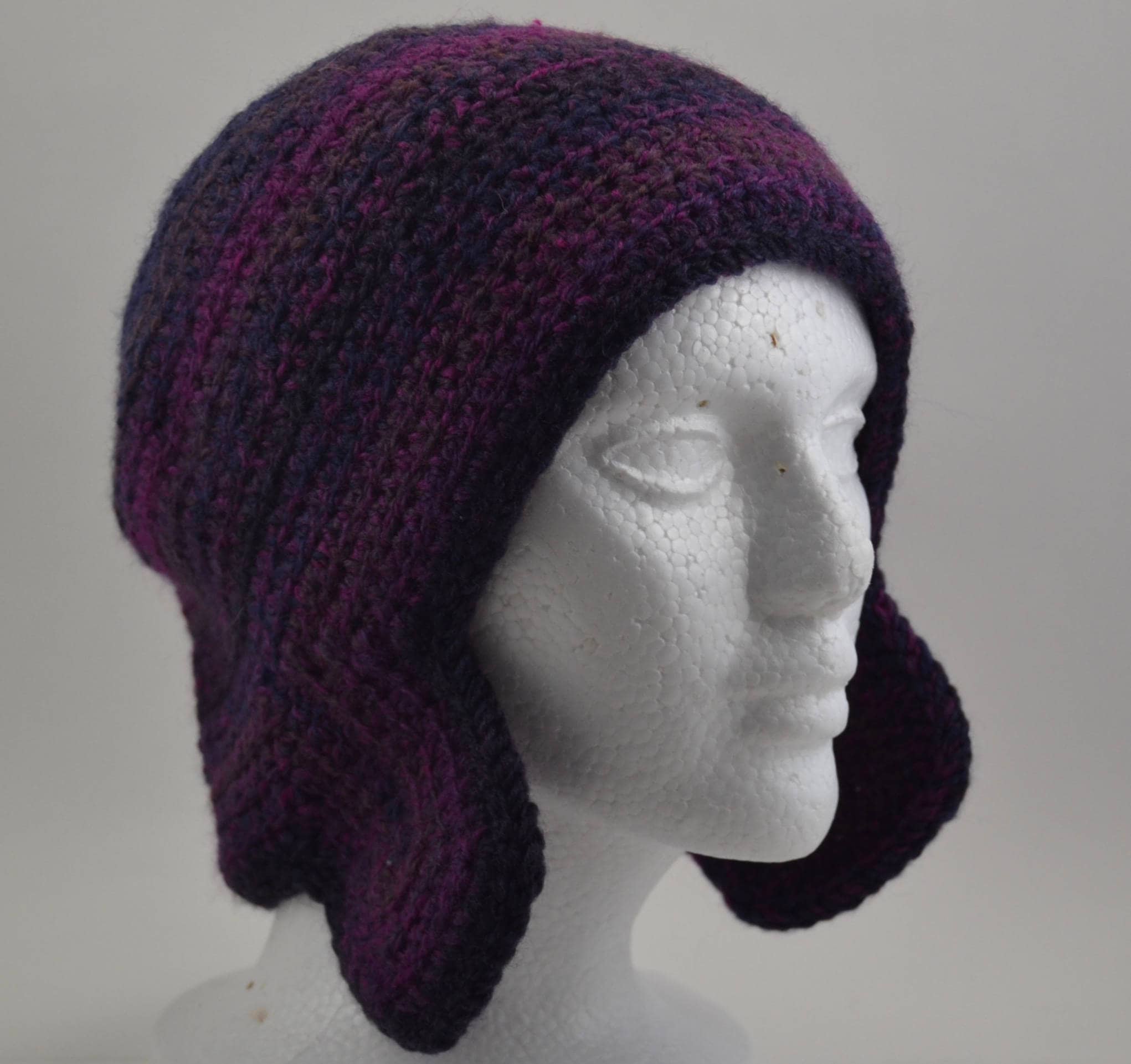 8 Ear Flap Hat Crochet Patterns for Cozy Winter Wear, Gifts, and Playful Style 4 Ear Flap Bomber Type Hat In Variegated Purple Tones