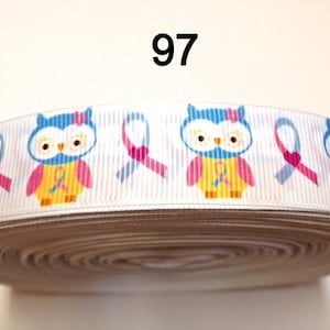 May include: White ribbon with a repeating pattern of blue and pink owls and pink ribbons. The owls have yellow and pink bodies and are wearing bows. The number "97" is printed in black at the top of the image. The ribbon is rolled up.