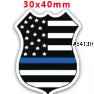 May include: A shield-shaped sticker featuring a black and white American flag design with a horizontal blue stripe across the center. The text 30x40mm is printed at the top, and the text #5413R is printed on the right side of the shield.