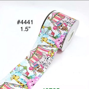 May include: A roll of 1.5-inch wide ribbon featuring a circus theme. The ribbon has a white background with illustrations of circus tents, animals, and floral accents. The text "#4441" is printed on the ribbon.