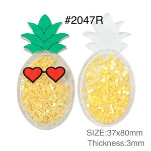 May include: Two pineapple-shaped acrylic charms labeled #2047R with dimensions 37x80mm and 3mm thickness. One features a green top, heart-shaped red sunglasses, and yellow star-shaped glitter inside. The other is clear with yellow star-shaped glitter.