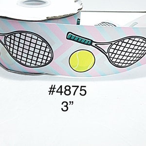 May include: A roll of ribbon with a tennis theme. The ribbon features a repeating pattern of tennis rackets, tennis balls, and diagonal stripes in pastel colors. The ribbon is 3 inches wide.
