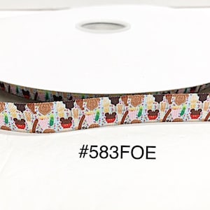 May include: A roll of white ribbon with a colorful pattern. The pattern includes images of ice cream, popcorn, and other treats. The text "#583FOE" is printed on the ribbon.