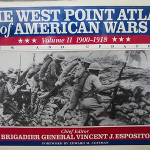 May include: The West Point Atlas of American Wars, Volume II, 1900-1918, featuring a black and white image of soldiers in a trench. The book cover has a blue and red banner with white text. The chief editor is Brigadier General Vincent J. Esposito.