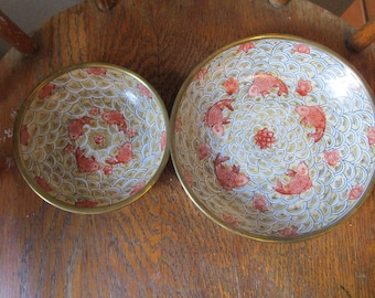 May include: Two round bowls with brass rims featuring a repeating blue and white wave pattern background. The interior of each bowl is decorated with orange koi fish and small red floral accents arranged in a circular, symmetrical design.