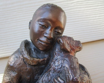 Sweet Austin Sculpture of a Boy, who genuinely loves his dog. Signed Ecila, 1995 Austin Sculptures.