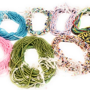 May include: Assortment of colorful beaded necklaces, some with a single color and others with multiple colors. The necklaces are made of small, round beads and are arranged in a circle.