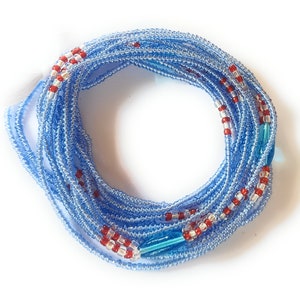 May include: A blue and red beaded waist chain with a decorative blue glass bead. The chain is made of small, round beads and is wrapped in a circle.