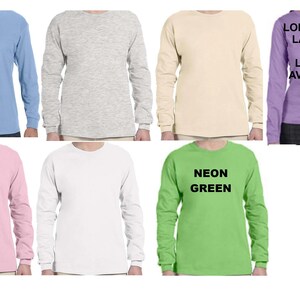May include: Six long-sleeve t-shirts in various colors, including light blue, gray, beige, pink, white, and neon green. The neon green shirt has the text "NEON GREEN" printed on the front.