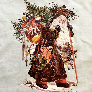 May include: A vintage Christmas fabric featuring a Santa Claus carrying a sack full of toys and a walking stick. The fabric is white with a light blue background and features a festive winter scene with holly and snow.