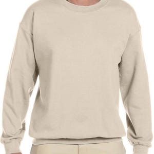 May include: A plain, light beige sweatshirt with long sleeves and a crew neck.