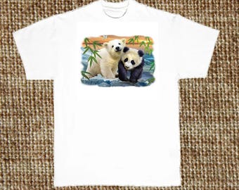 May include: White t-shirt featuring a colorful graphic of a polar bear and a panda bear standing together. The graphic includes bamboo and a sunset background. The shirt is made of a soft, comfortable material.