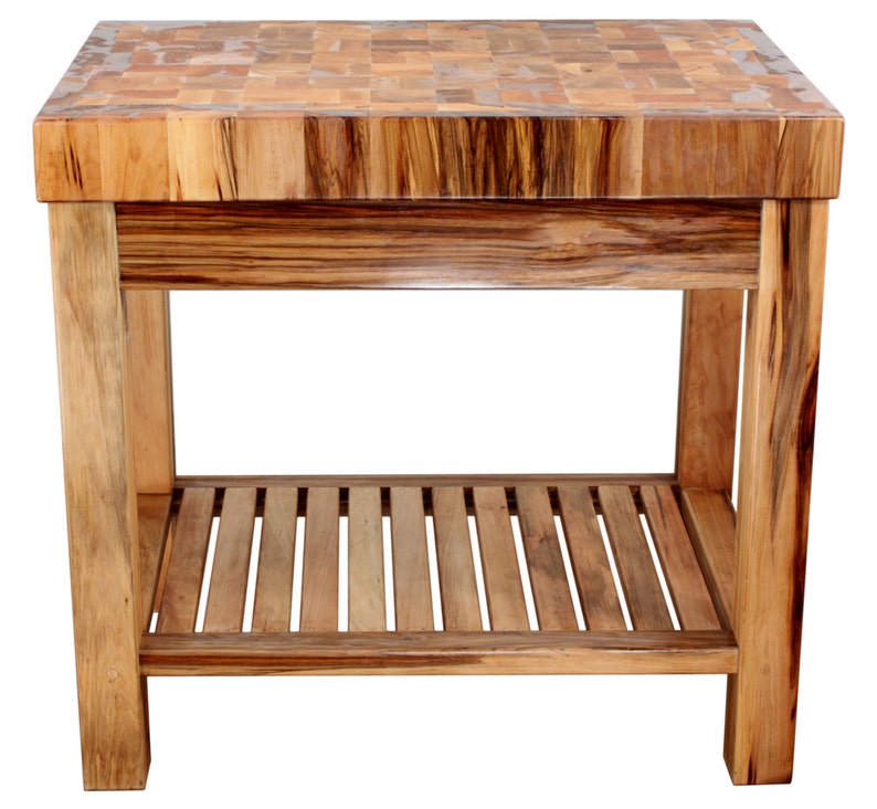 May include: A wooden butcher block kitchen island with a butcher block top and a lower shelf. The island is made of light brown wood with a natural finish.