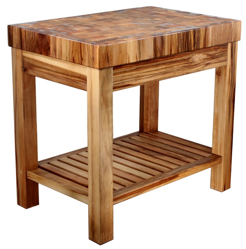 May include: A wooden butcher block kitchen island with a butcher block top and a lower shelf. The island is made of natural wood with a light brown finish.