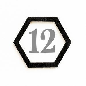 May include: A black hexagonal frame with the number 12 printed in gray inside.
