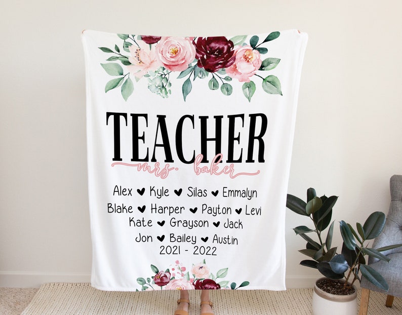 May include: White fleece blanket with a floral design and the text "TEACHER mrs. baker" in black. Below the text are the names of students, "Alex, Kyle, Silas, Emmalyn, Blake, Harper, Payton, Levi, Kate, Grayson, Jack, Jon, Bailey, Austin" and the dates "2021 - 2022".