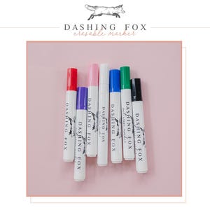 four different colored pens sitting next to each other