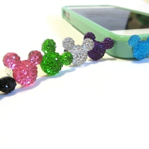 May include: A set of six colorful rhinestone Mickey Mouse head phone charms. The charms are in black, pink, green, silver, purple, and blue.