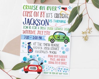 May include: A colorful invitation with the text "Cruise on Over" and "Let's Celebrate Jackson". The invitation features car illustrations and event details, including the date, time, and location. A brown envelope and greenery frame the invitation.