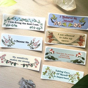 May include: Set of 6 colourful stickers with floral designs and inspirational quotes. The quotes include "I am doing the best I can", "I believe in myself", "I am allowed to take up space", "I choose me", "My sensitivity makes me strong", and "Taking care of myself is important."