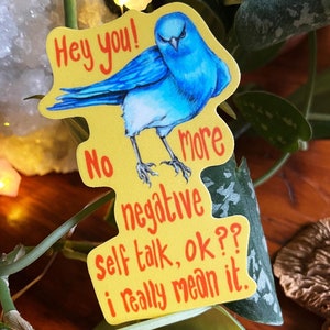 Może przedstawiać: Żółta naklejka z ilustracją niebieskiego ptaka i tekstem "Hey you! No negative self talk, ok?? I really mean it."