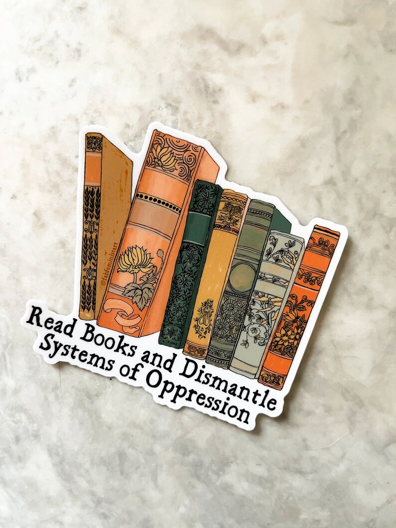 May include: A sticker with a stack of vintage books with ornate covers and the text "Read Books and Dismantle Systems of Oppression".