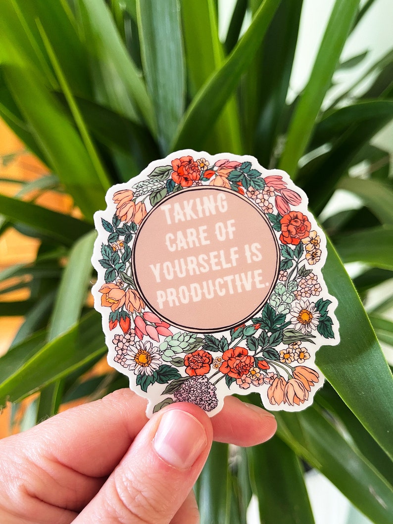 May include: A sticker with a floral wreath design and the text "Taking care of yourself is productive."