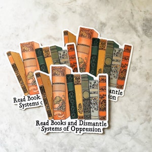 May include: A sticker with a stack of vintage books and the text "Read Books and Dismantle Systems of Oppression".