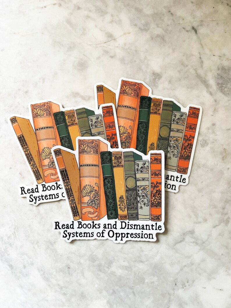 May include: A sticker with a stack of vintage books and the text "Read Books and Dismantle Systems of Oppression".