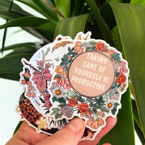 May include: A set of floral stickers with a pink circle in the centre that says "Taking care of yourself is productive."