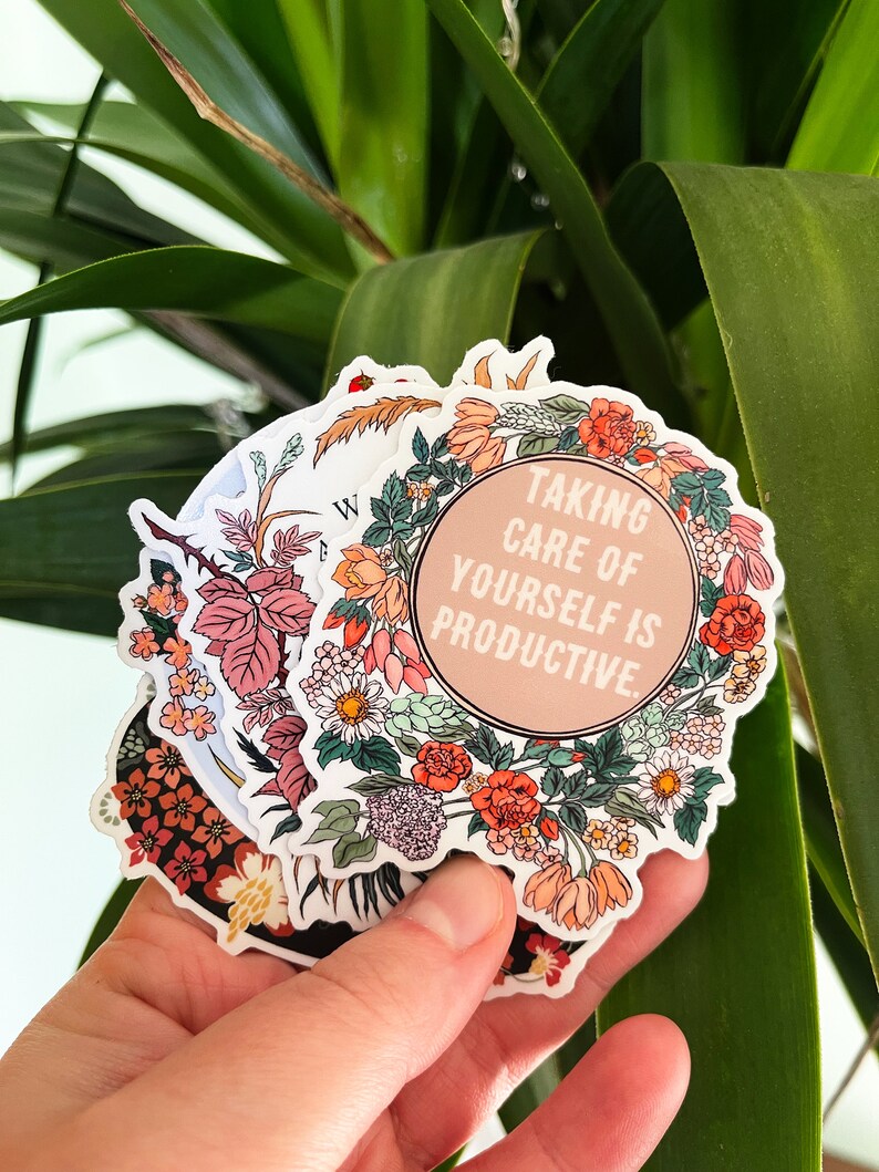 May include: A set of floral stickers with a pink circle in the centre that says "Taking care of yourself is productive."