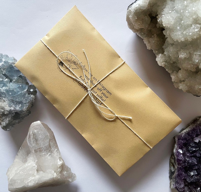 May include: A brown paper envelope tied with twine, with the text "Follow me on Instagram and check off your Fab Finds list! @stabler.krist" printed on the front.