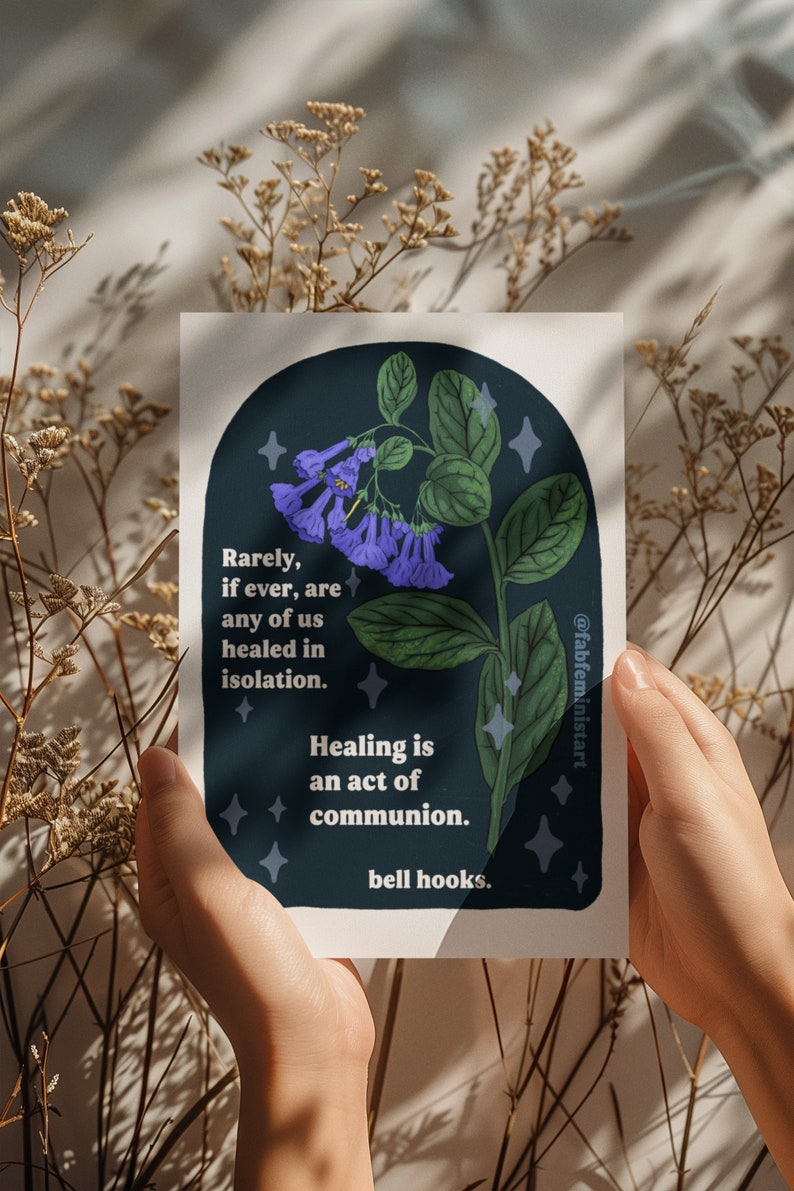 May include: A dark blue background with a white border features a purple flower with green leaves and white stars. The text reads "Rarely, if ever, are any of us healed in isolation. Healing is an act of communion. bell hooks."
