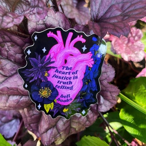 Puede incluir: Una pegatina en forma de coraz&oacute;n con un coraz&oacute;n anat&oacute;mico rosa y dise&ntilde;os florales negros. El texto dice "The heart of justice is truth telling bell hooks".