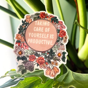 May include: A pink and white sticker with a floral border and the text "Taking care of yourself is productive."