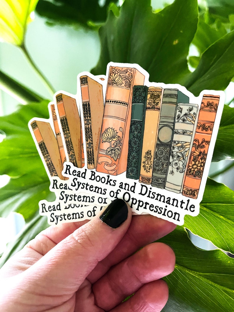 May include: A sticker with a stack of vintage books and the text "Read Books and Dismantle Systems of Oppression".