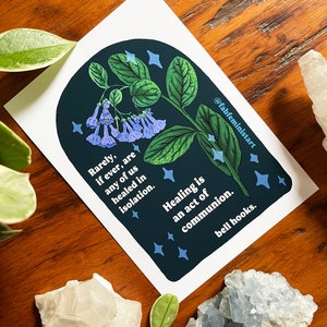 May include: A blue and green illustration of a plant with blue flowers and white stars on a dark blue background. The text reads "Rarely, if ever, are any of us healed in isolation. Healing is an act of communion. bell hooks."