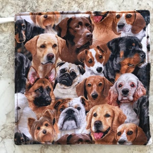 May include: A colorful fabric pot holder with a pattern of various dog breeds, including a Labrador Retriever, a German Shepherd, a Pug, and a Bulldog.
