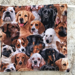 May include: A colorful fabric pot holder with a pattern of various dog breeds, including a bulldog, golden retriever, labrador, poodle, and rottweiler.