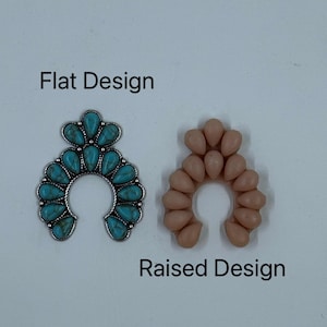 May include: Two horseshoe-shaped pendants. One features turquoise-colored stones set in a silver-toned metal frame, labeled "Flat Design." The other, labeled "Raised Design," is made of peach-colored teardrop-shaped beads.