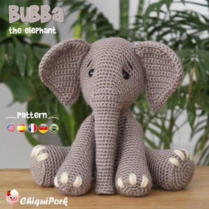 May include: A grey crocheted elephant toy with large ears, a long trunk, and cream-colored stitched toenails. The text "BuBba the elephant" and "Pattern" are visible, along with small flag icons and the brand name "ChiquiPork" at the bottom.