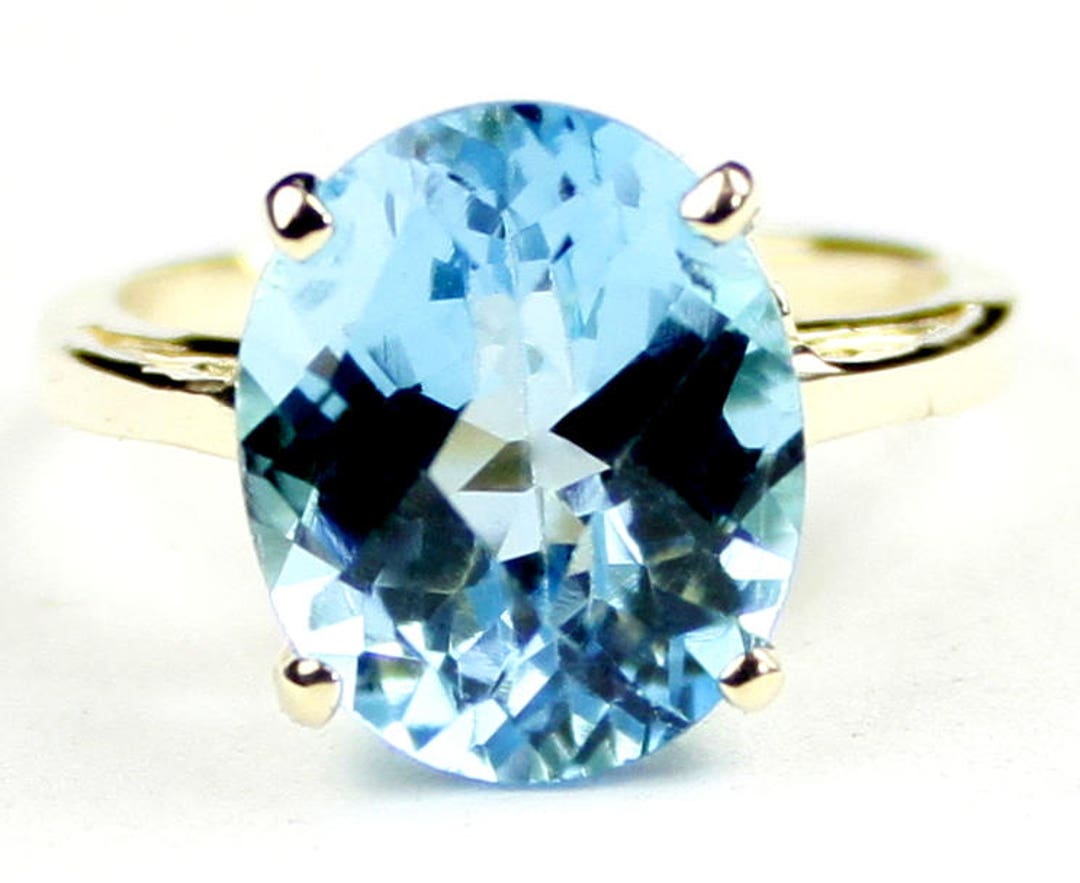 18k gold ring with big ass blue topaz